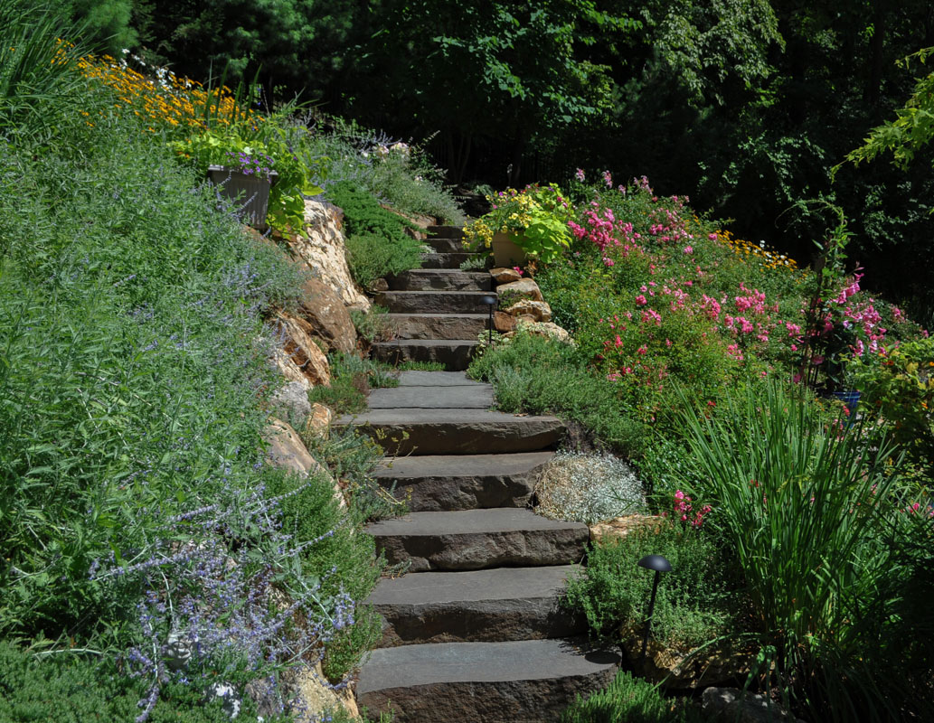 stone slab steps up sloped backyard