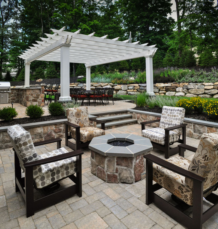gas fire pit and pergola highlight this landscape design