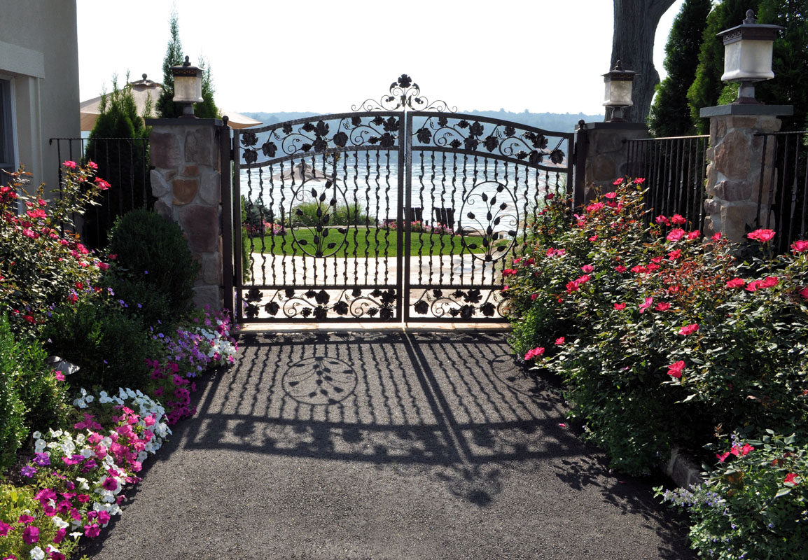 petunias and knock out roses frame entrance gate - nj