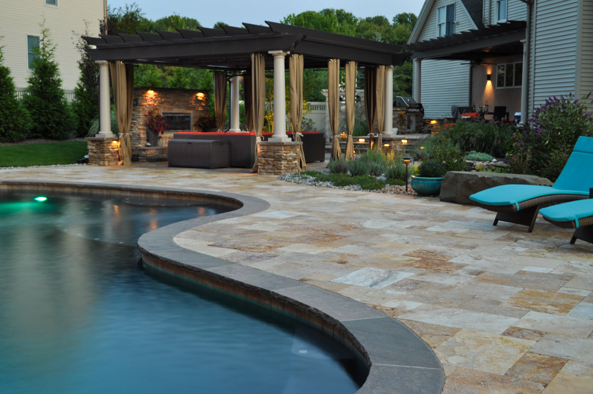 pool, patio, and pergola with landscape lighting design