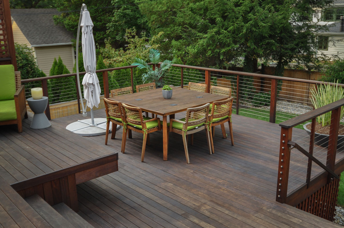 deck dining table with eight wood chairs around it - north jersey