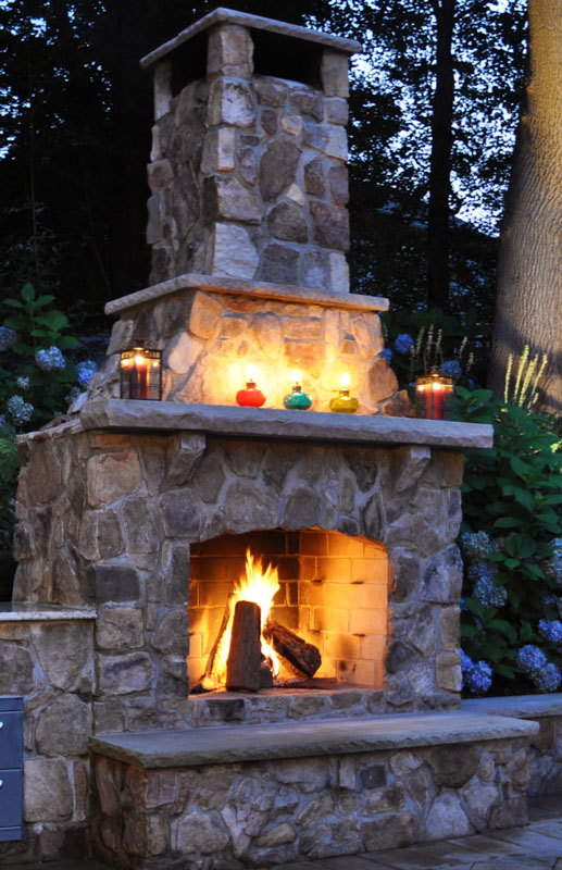 fire burning in custom outdoor fireplace