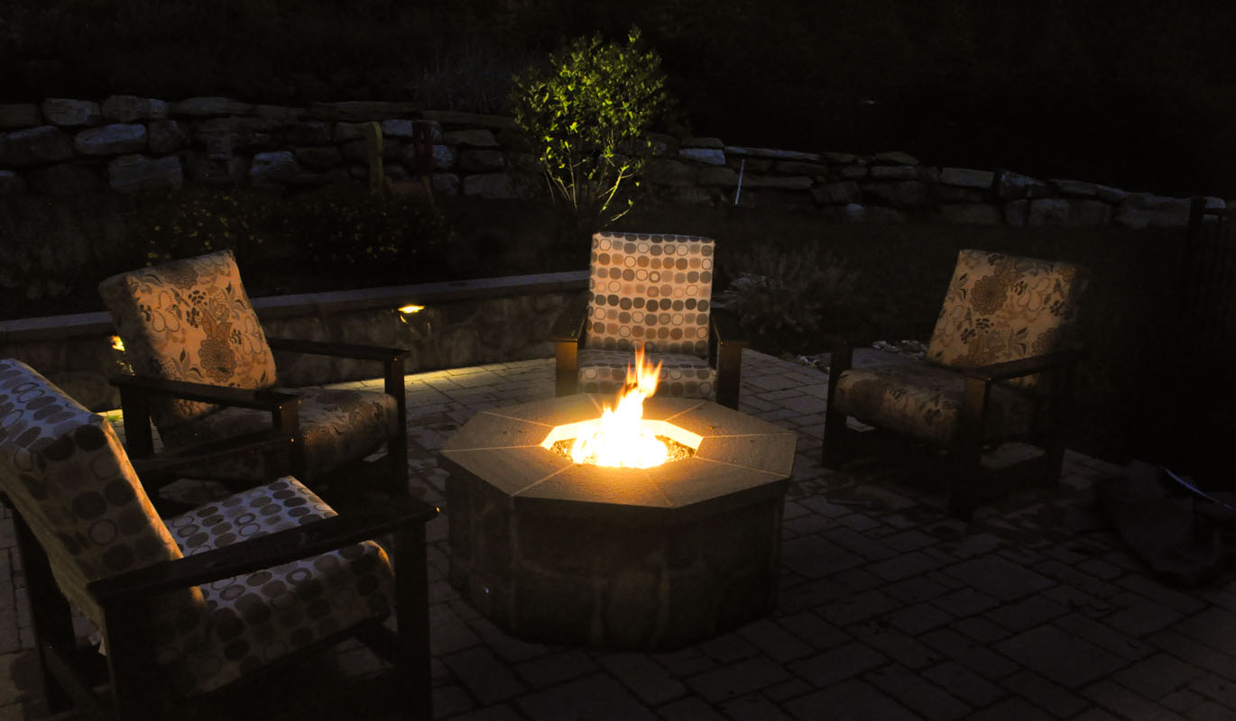 gas fire pit with fire burning, bluestone cap