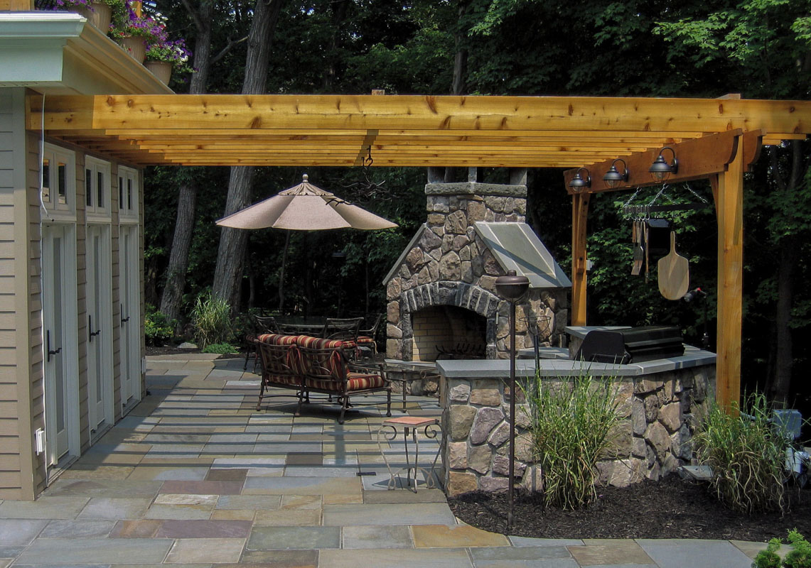 built in bbq and outdoor fireplace under pergola