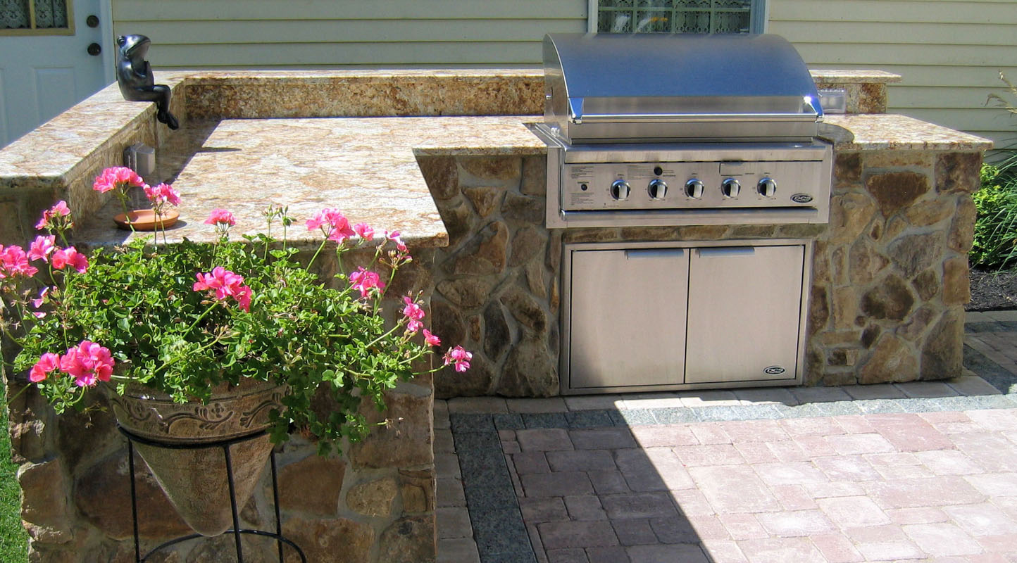 built in outdoor bbq with granite countertop