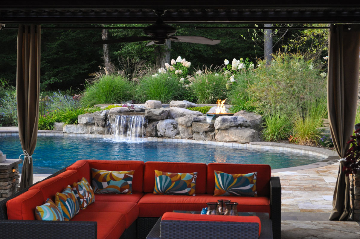 swimming pool with stone pool waterfall and fire feature - north jersey