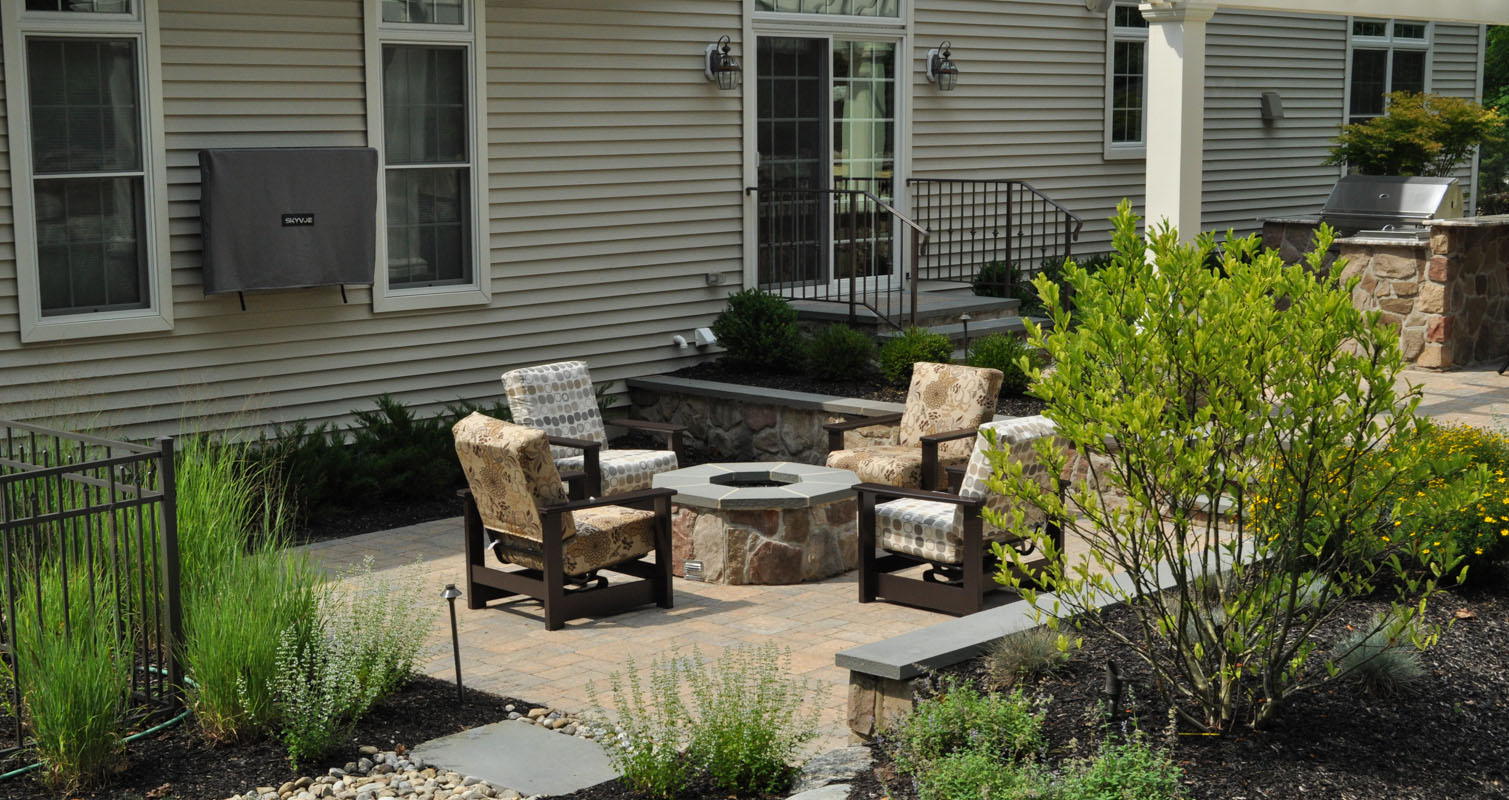 outdoor television mounted on house, gas fire pit with bluestone cap on patio - north jersey