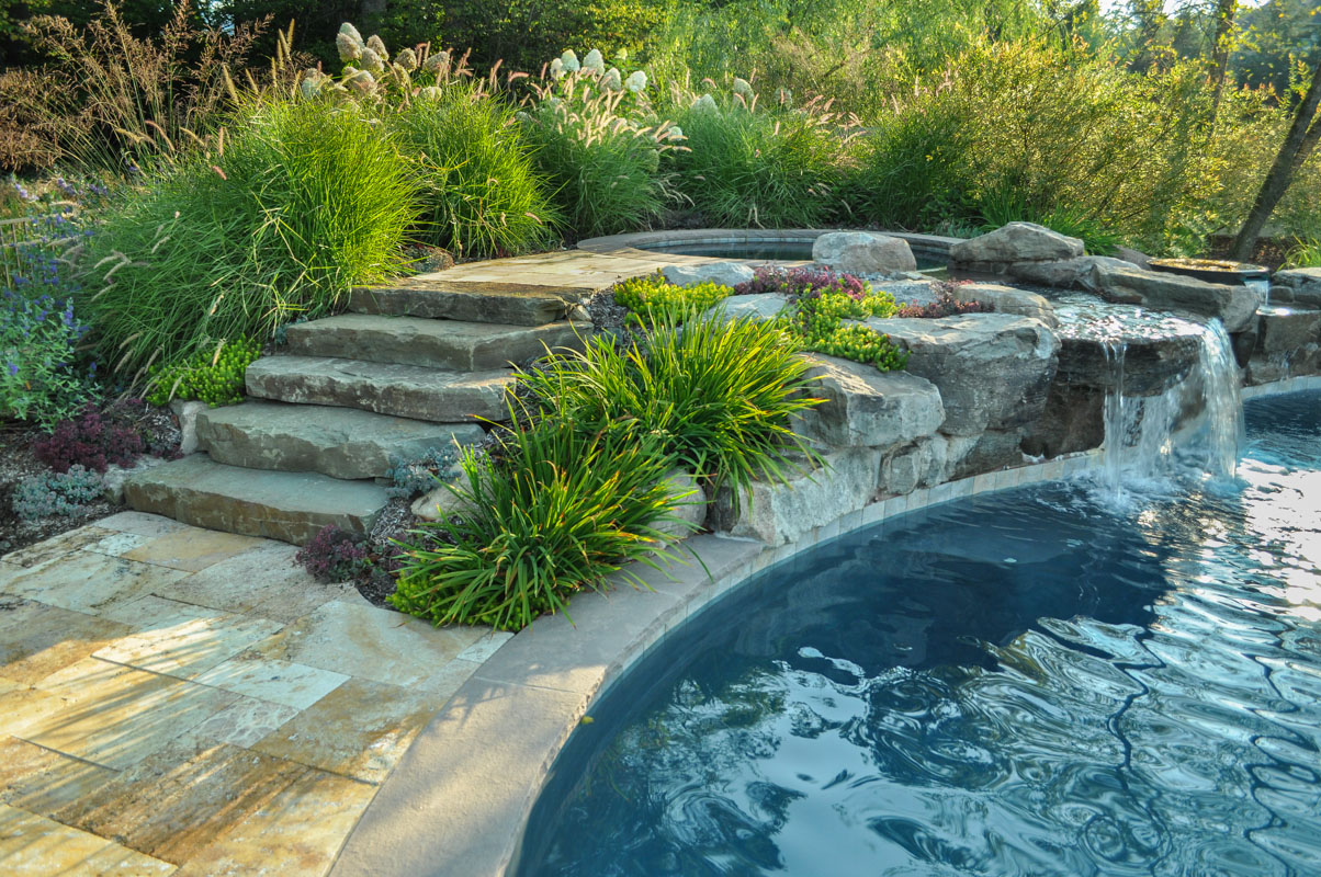 natural stone steps lead to spa in nj swimming pool