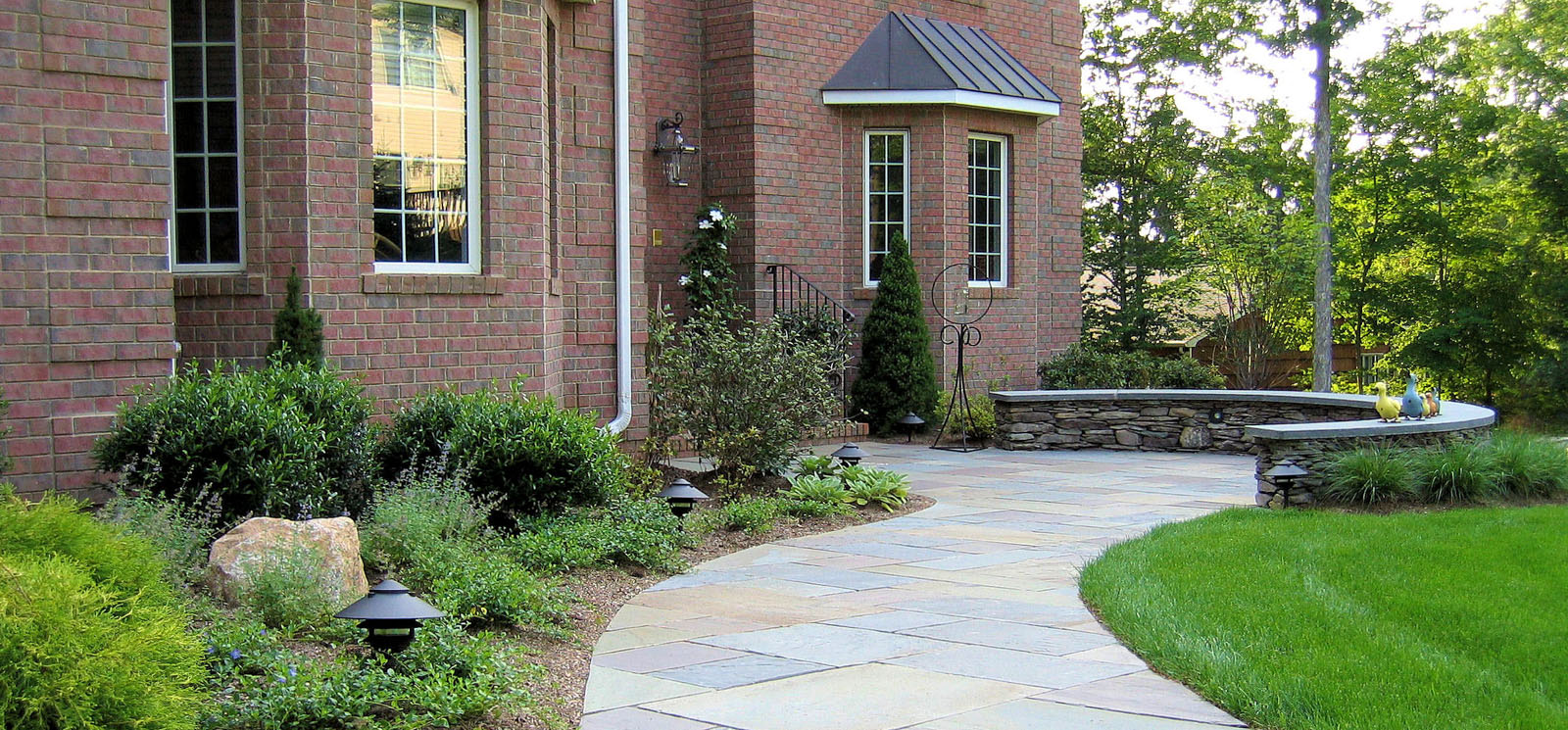 bluestone walkway with patio area and curved seat wall