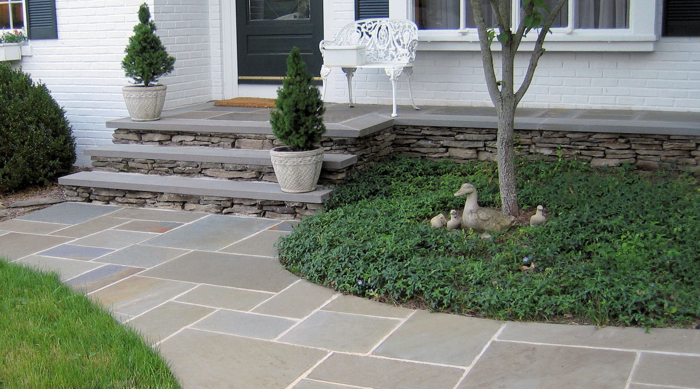 bluestone front walk leads to stone slab steps and front porch