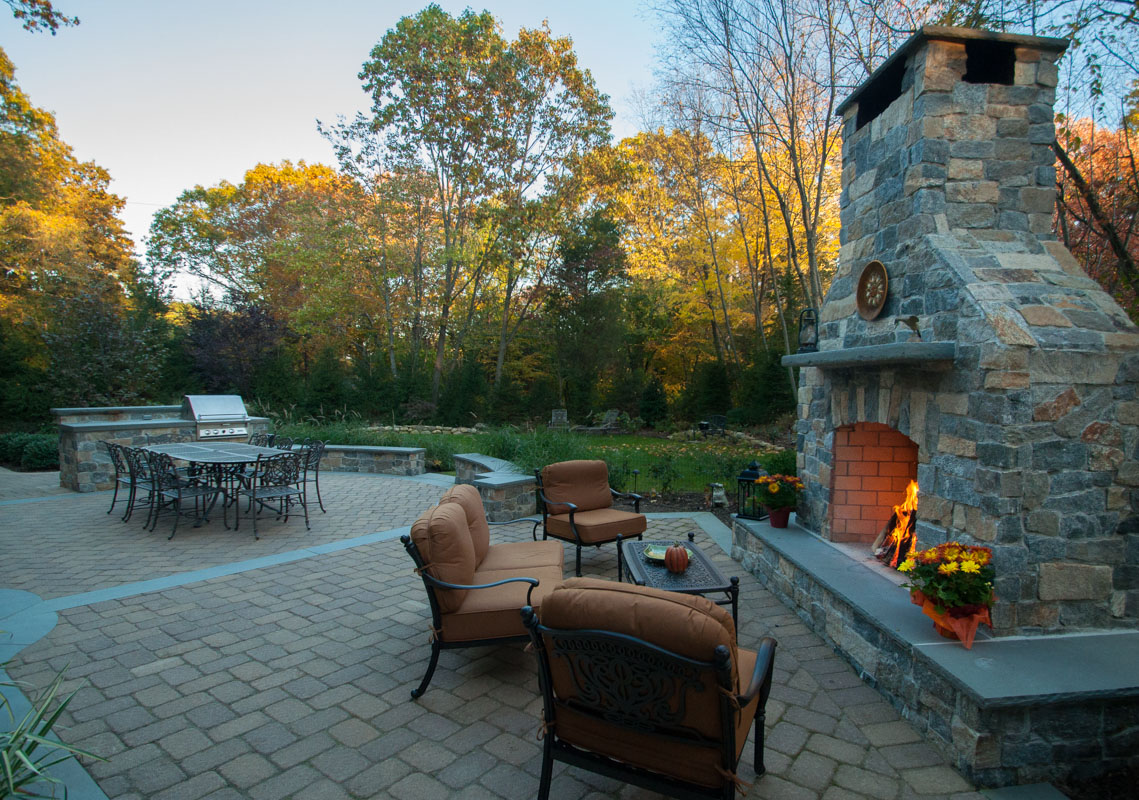 outdoor fireplace and wall with granite veneer