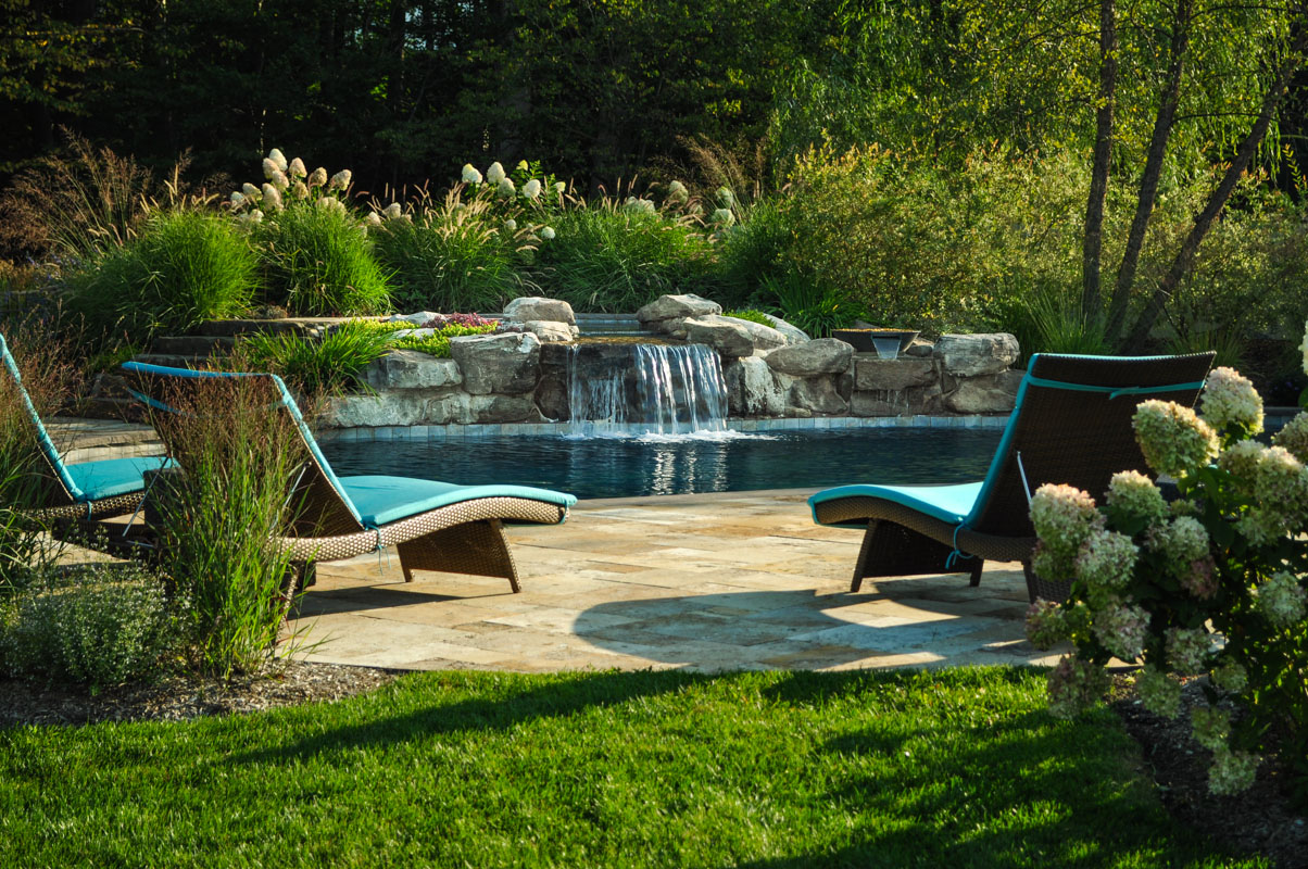 custom swimming pool with natural stone waterfall