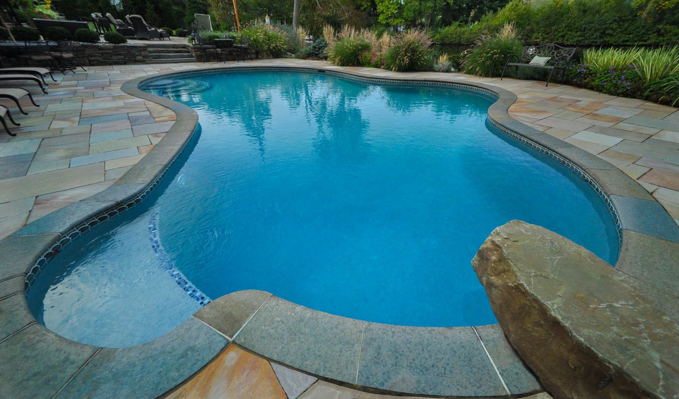 custom swimming pool design with dive rock, antique tennessee tan patio