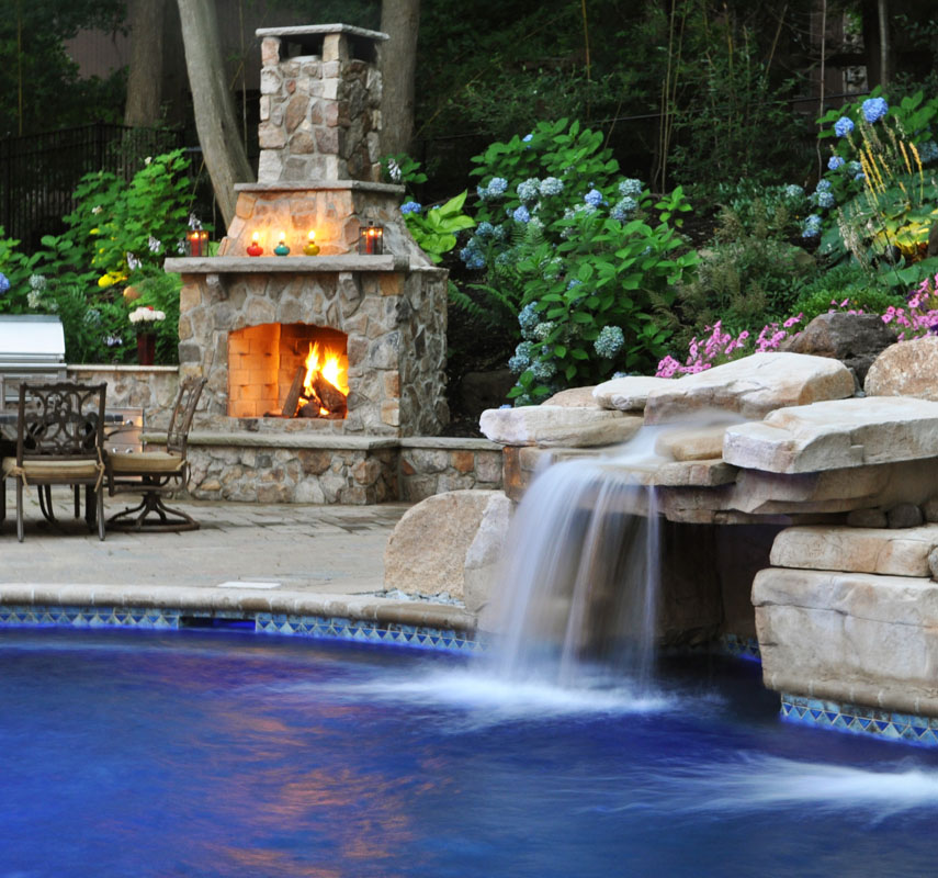 pool waterfall, grotto, and outdoor fireplace