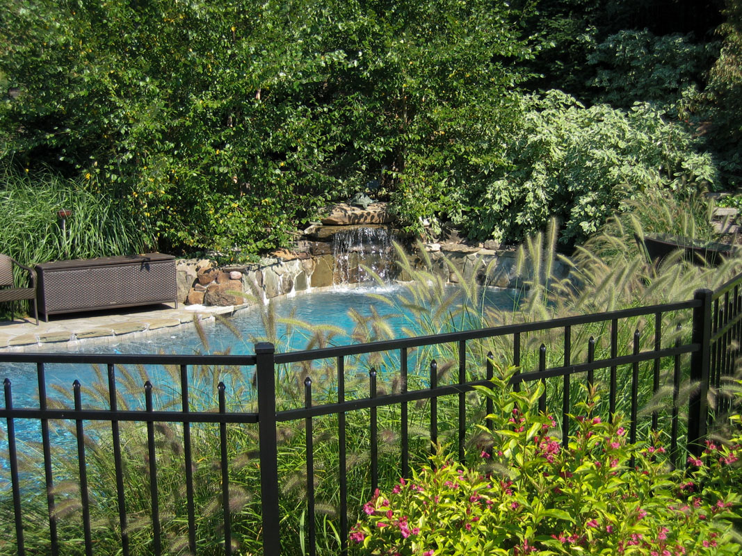 custom pool design with waterfall and landscaping