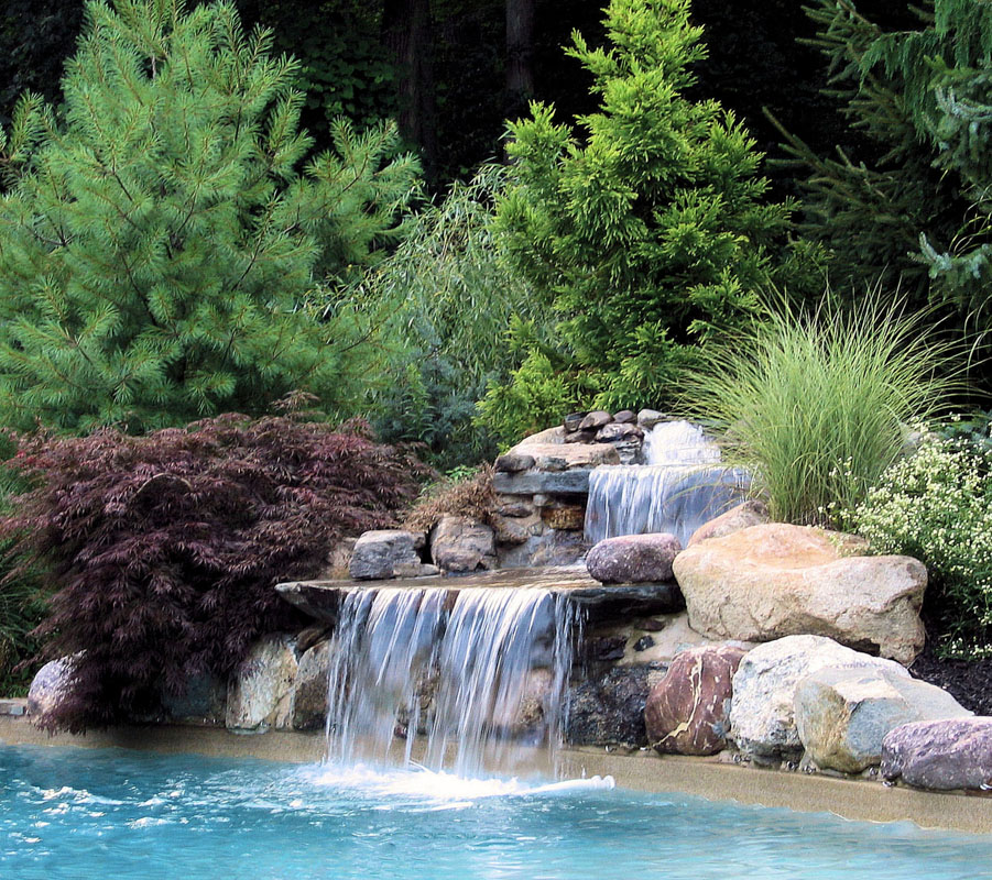 pool waterfall using natural stones, pool landscape design