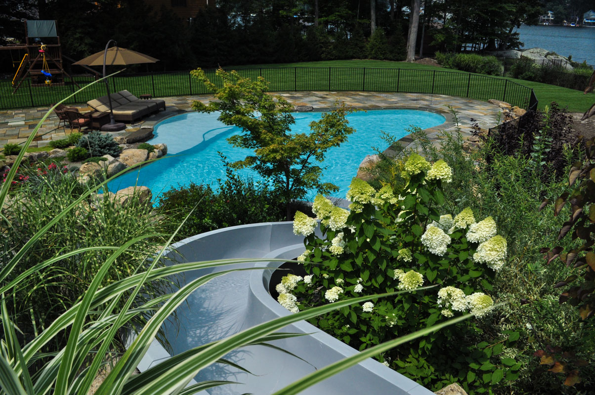 pool waterslide into custom designed swimming pool