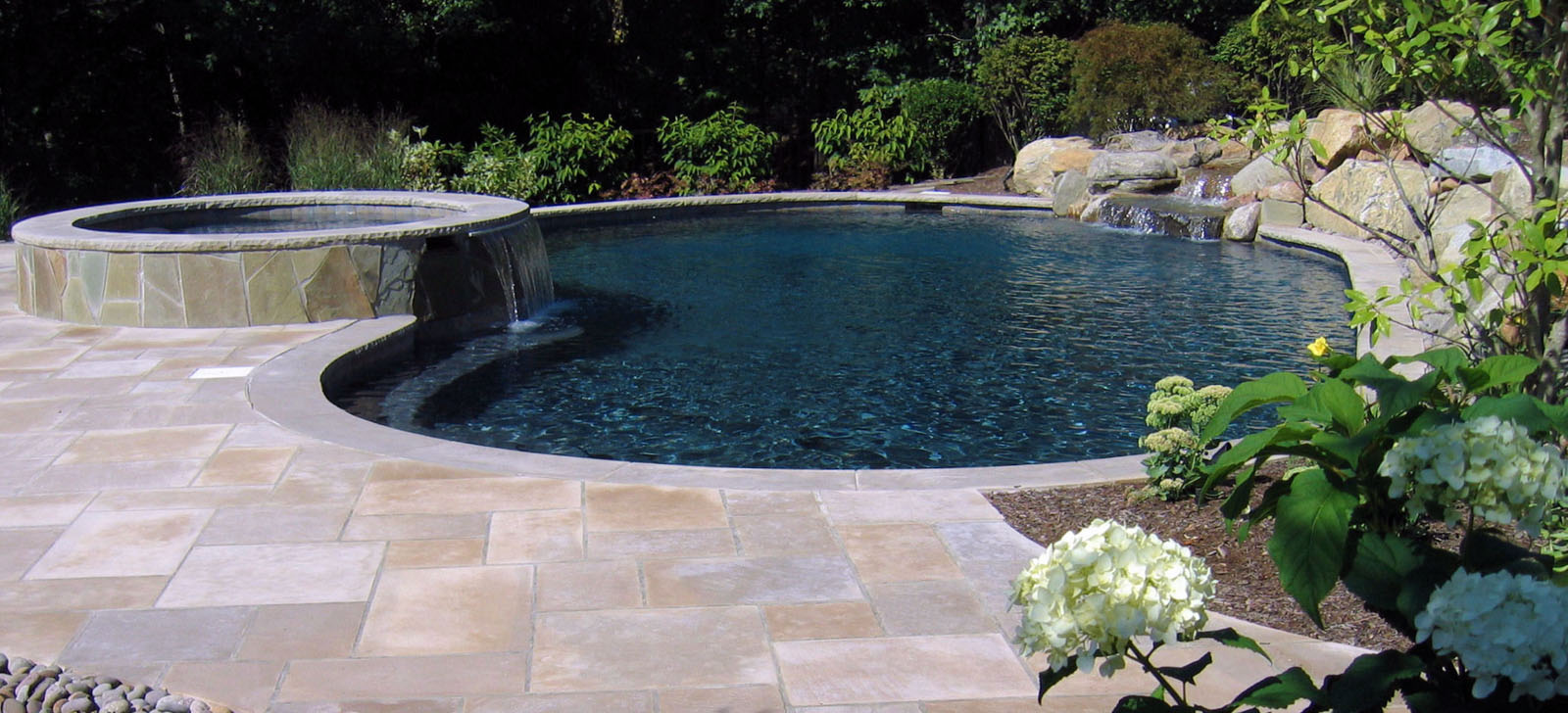 custom pool design with spa and pool waterfall