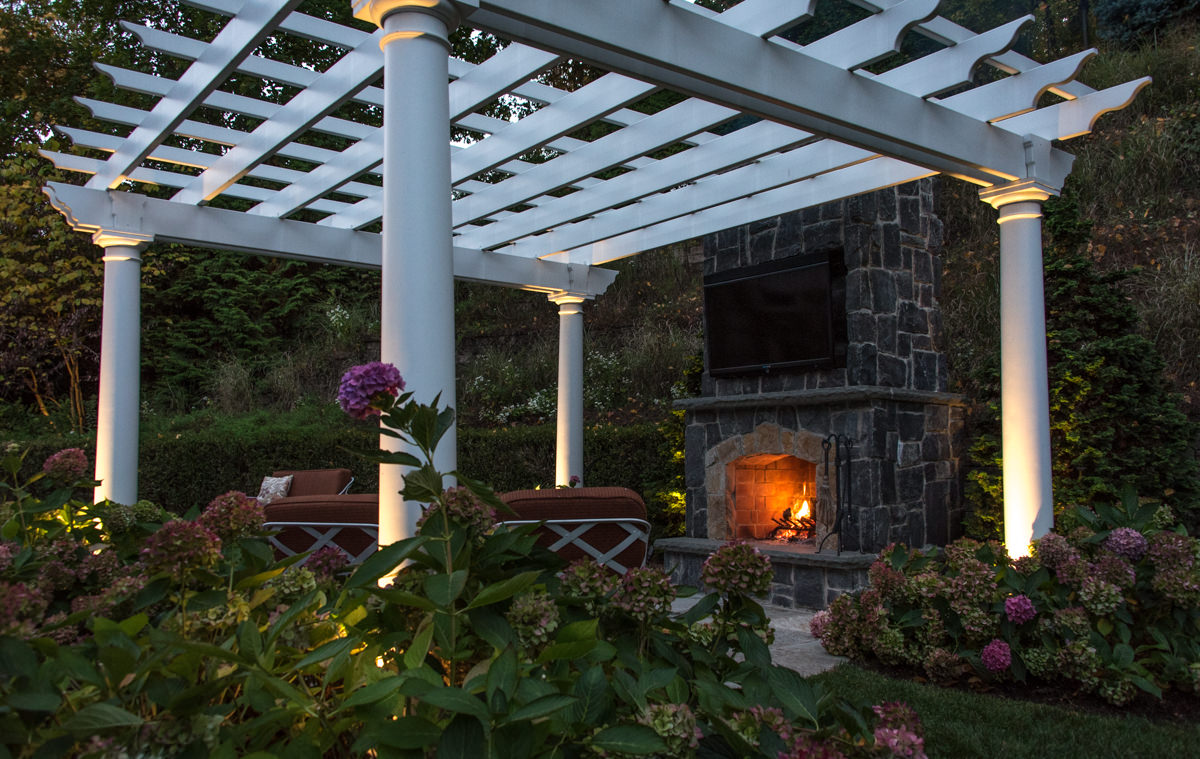 white pergola with outdoor fireplace