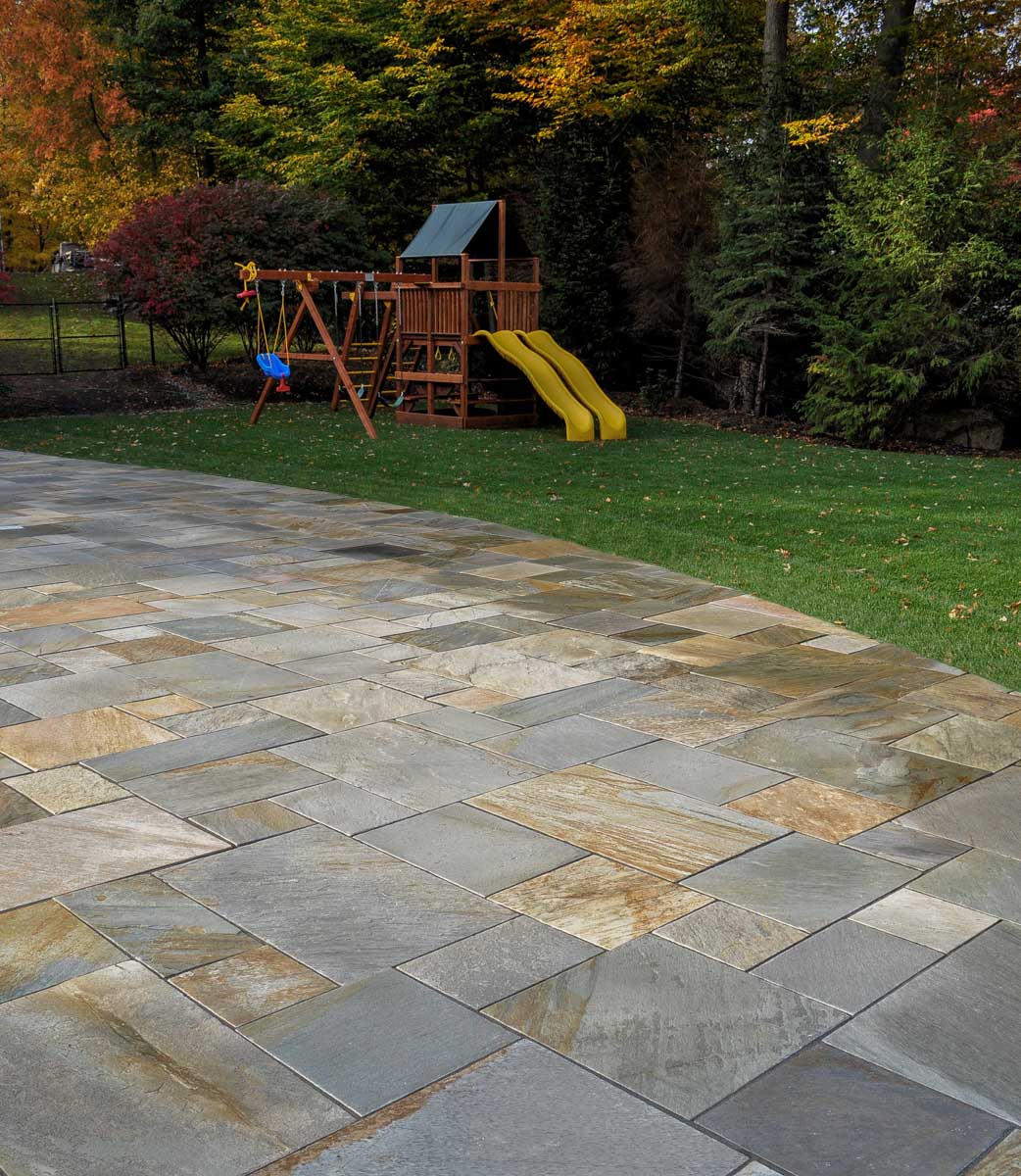 natural stone patio, lawn, swing set