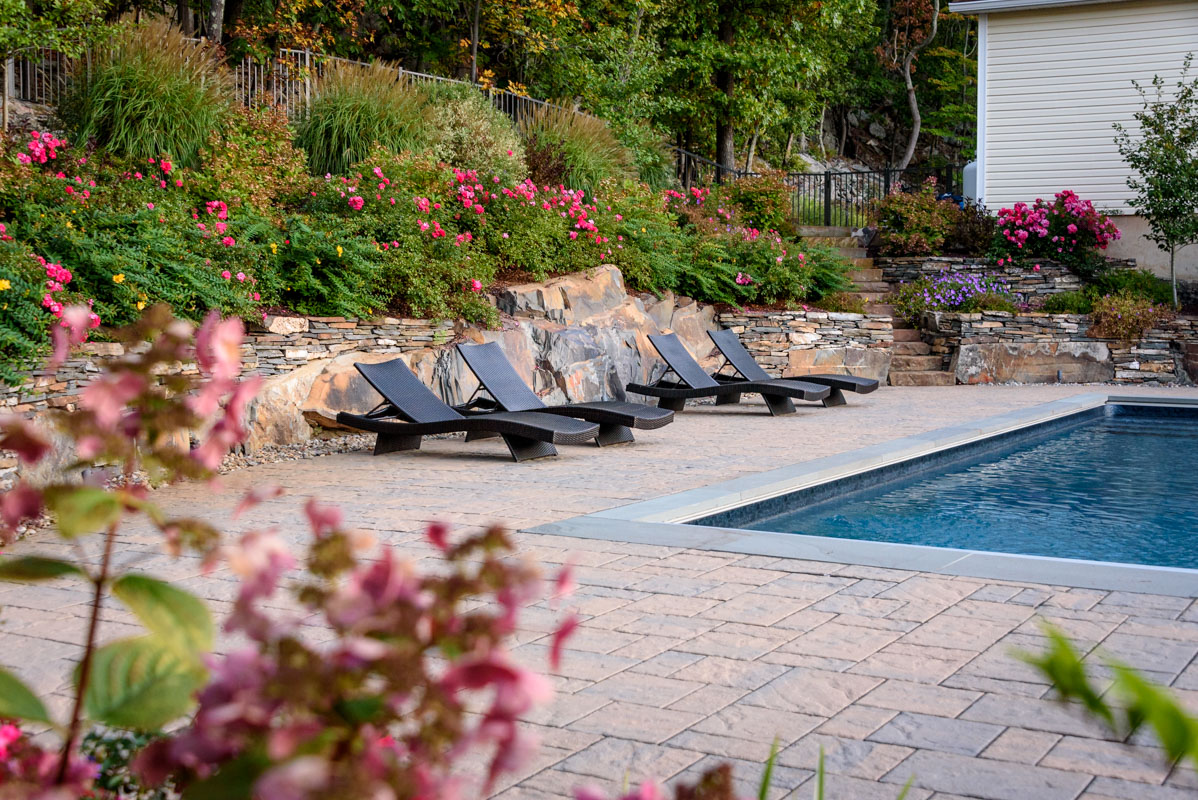 lounge chairs in front of natural stone wall