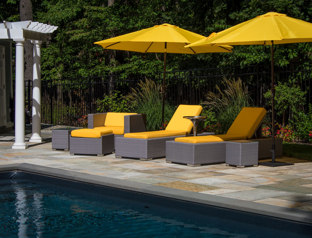 yellow lounge chairs and umbrellas poolside