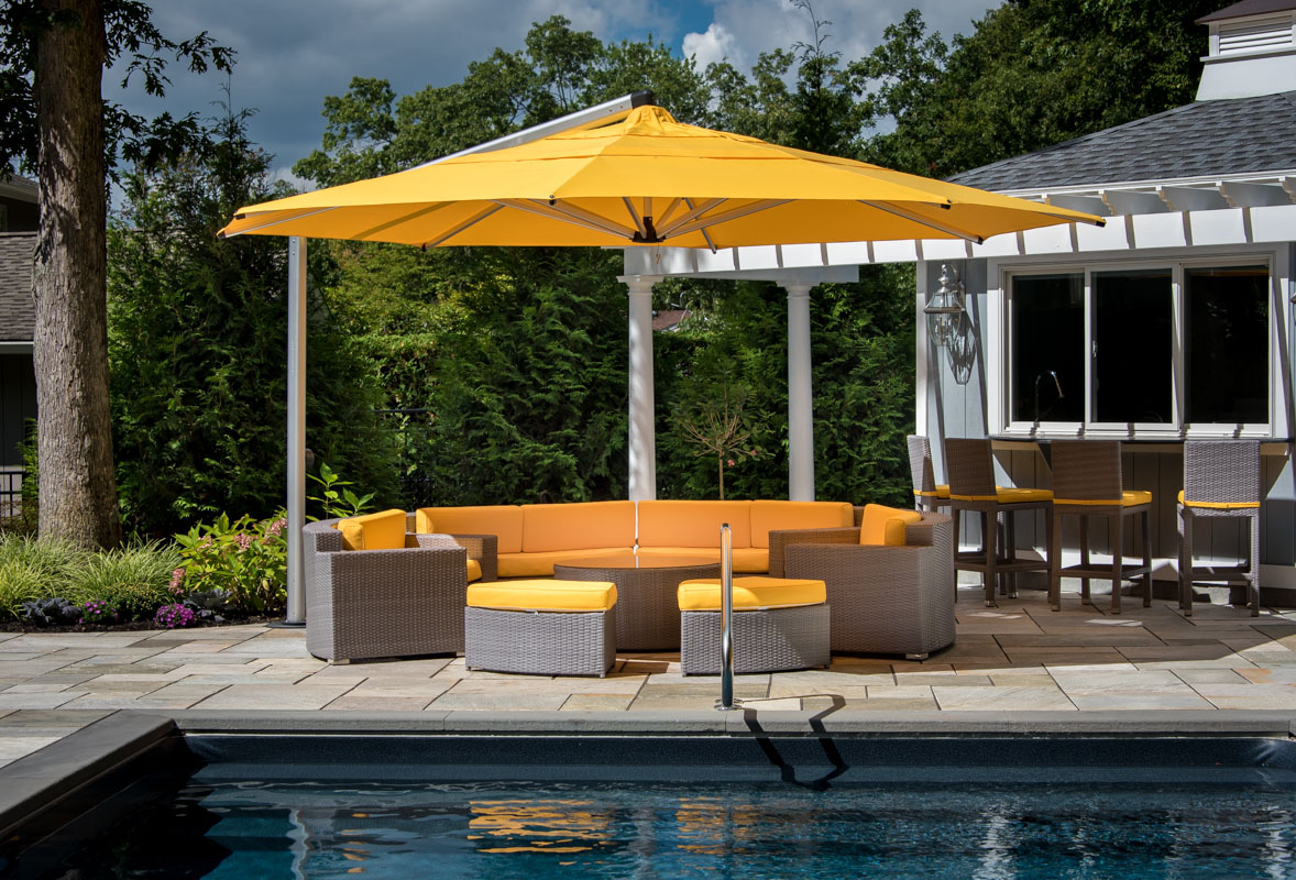 yellow umbrella and circular seating area in livingston pool area