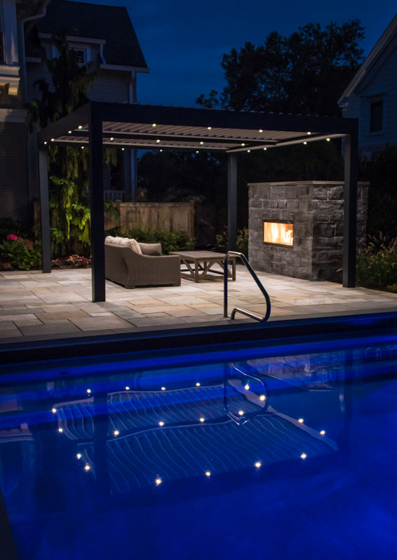 pergola with inset lighting, outdoor fireplace