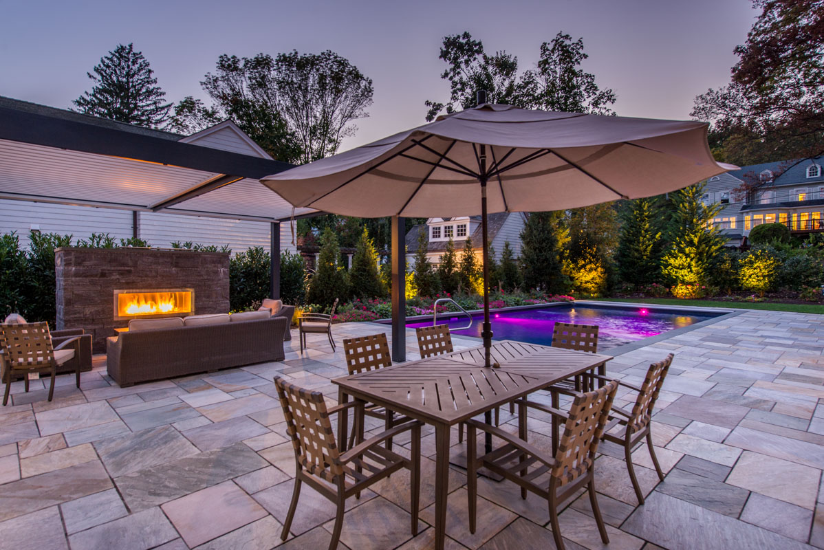 norwegian buff pool patio, gas outdoor fireplace under louvered pergola