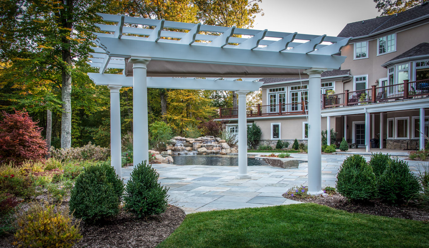white pergola with swimming pool in background