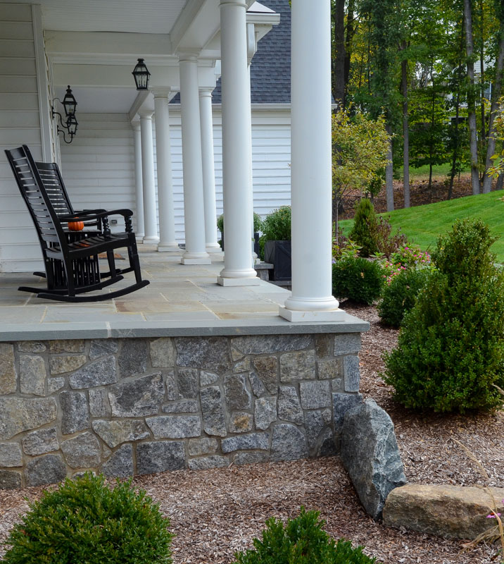 view of raised bluestone porch from the side