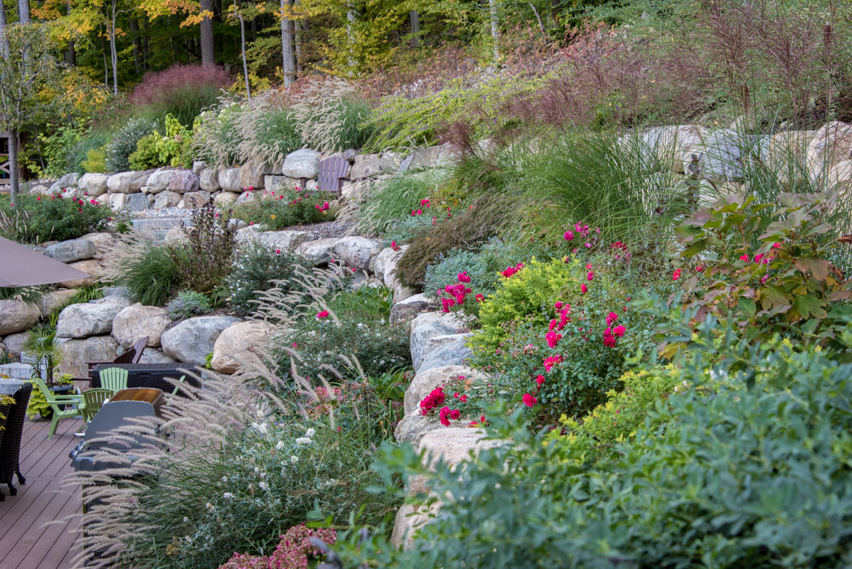 heavily planted terraces created with boulder retaining walls