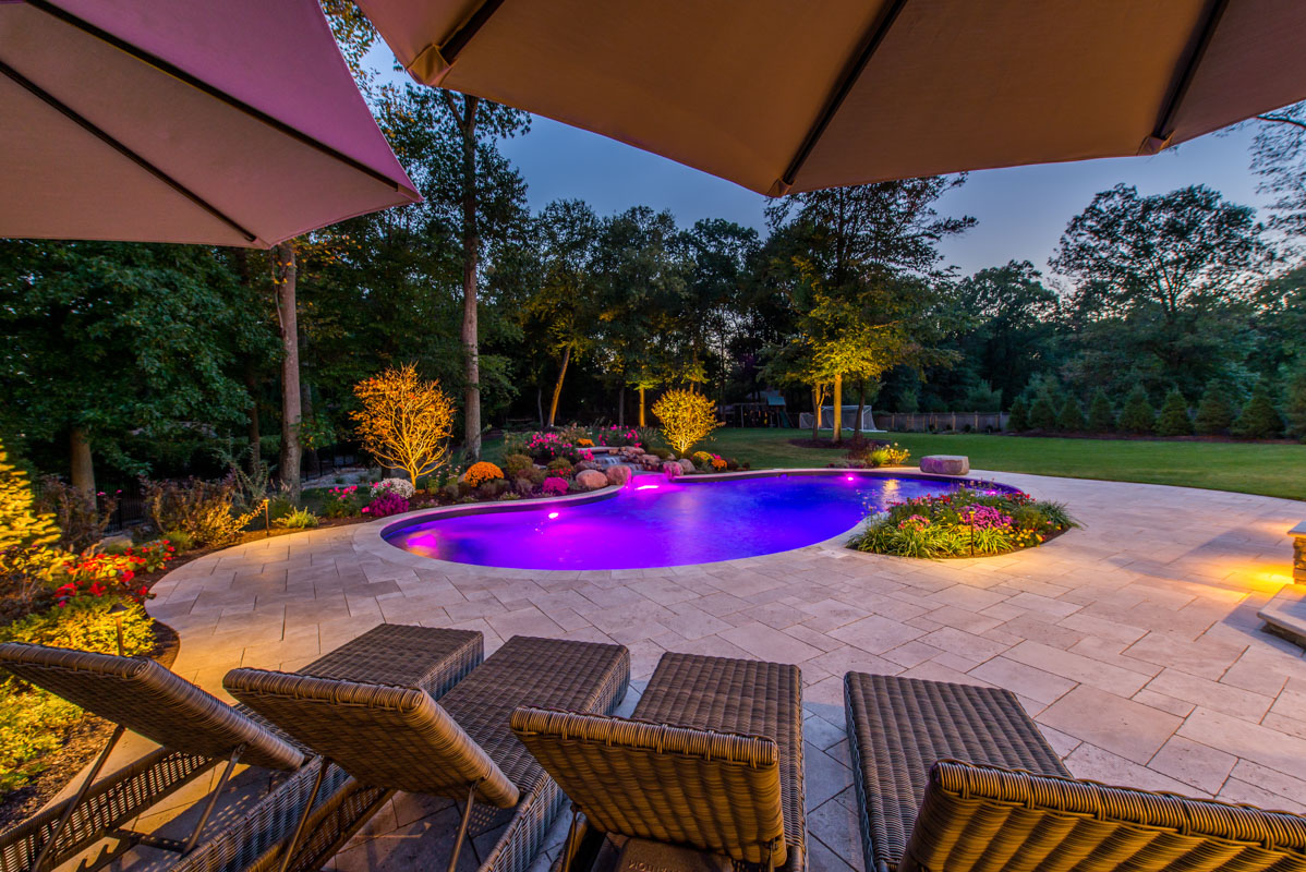 north nj swimming pool and surrounding landscape at night, landscape lighting