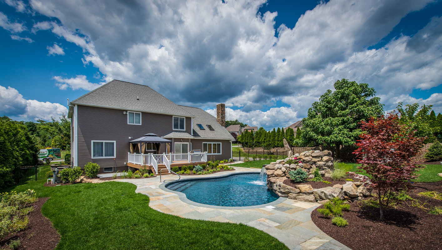 northern nj landscape design with swimming pool, waterfall, and patio