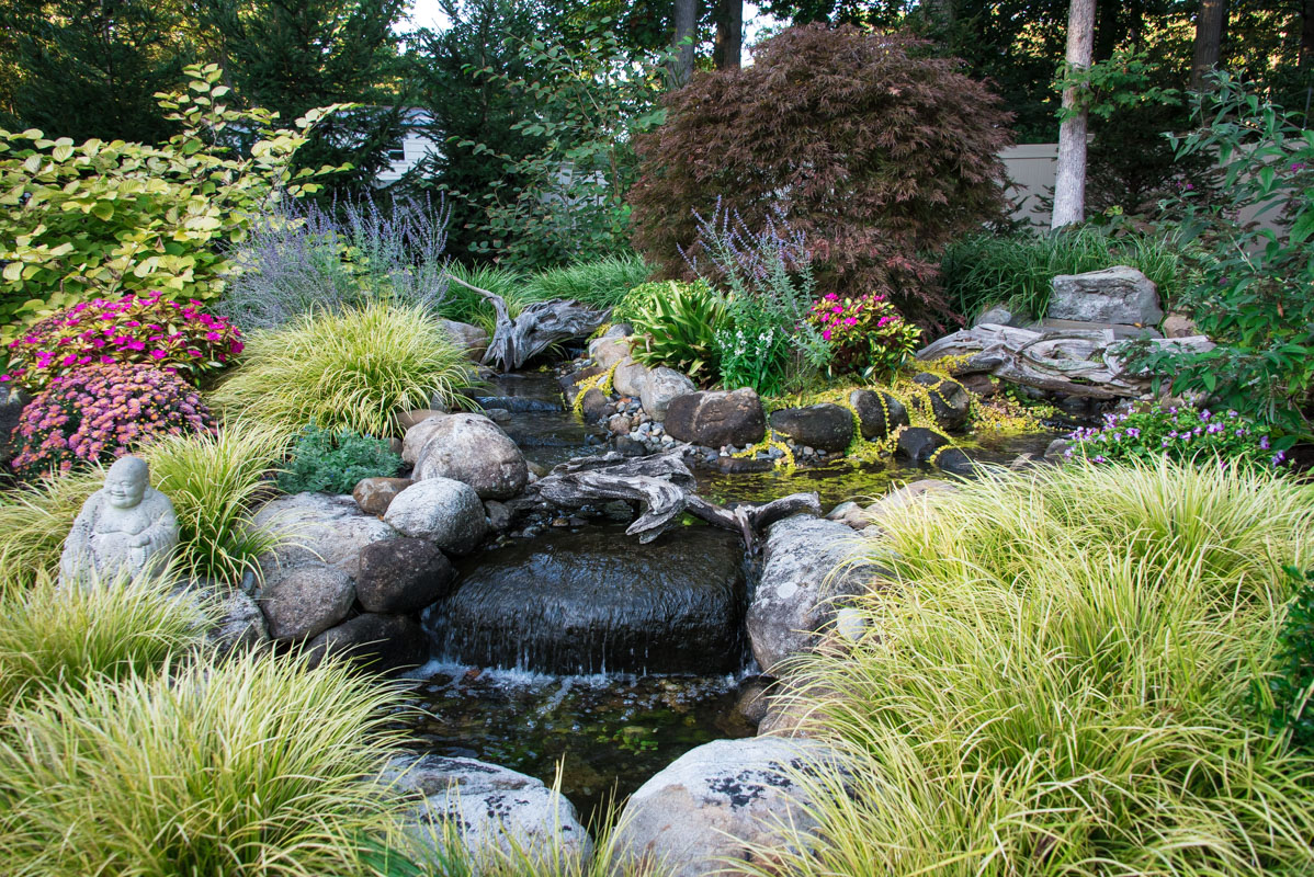 northern nj water feature in lush landscape