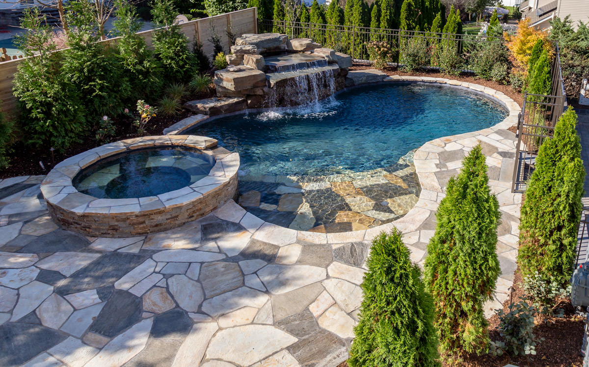 gunite swimming pool with sundeck, waterfall and spa