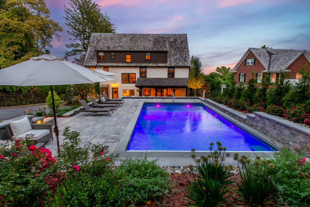 Luxury mountainside pool landscape in Montclair NJ with stone hardscape and lush plantings.