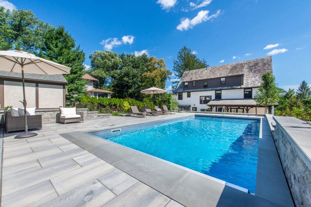 Pool area illuminated with modern outdoor lighting in Montclair NJ.