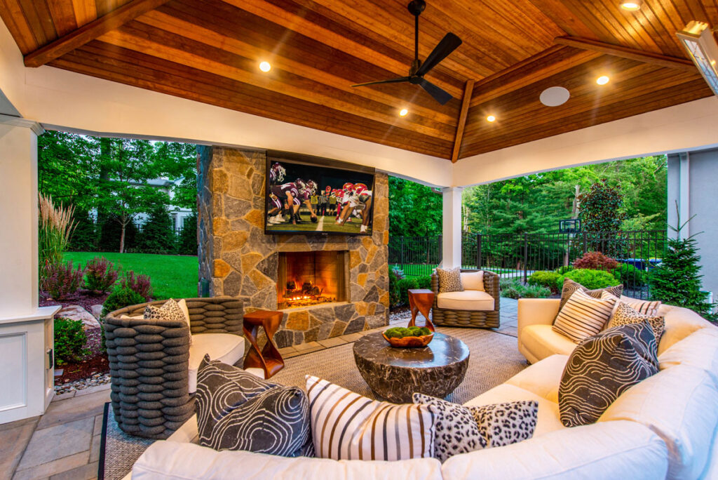 Lavish multizone backyard with modern pool, seating, and garden lighting.