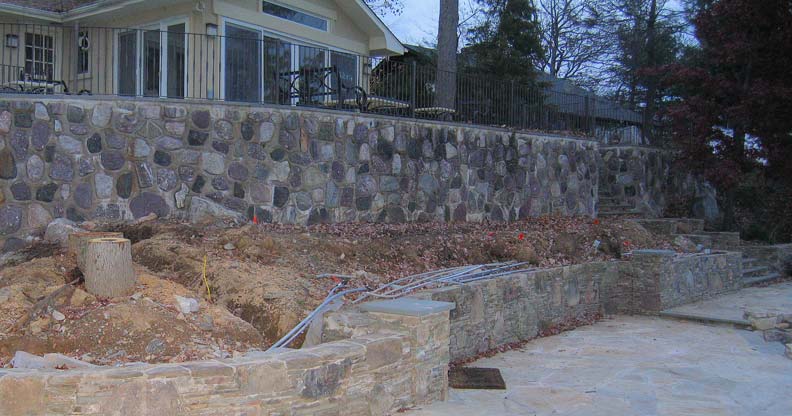 Before and after of a backyard transformed from an empty lawn into a poolside escape with natural stone waterfall, turquoise lounge chairs, and vibrant plantings.