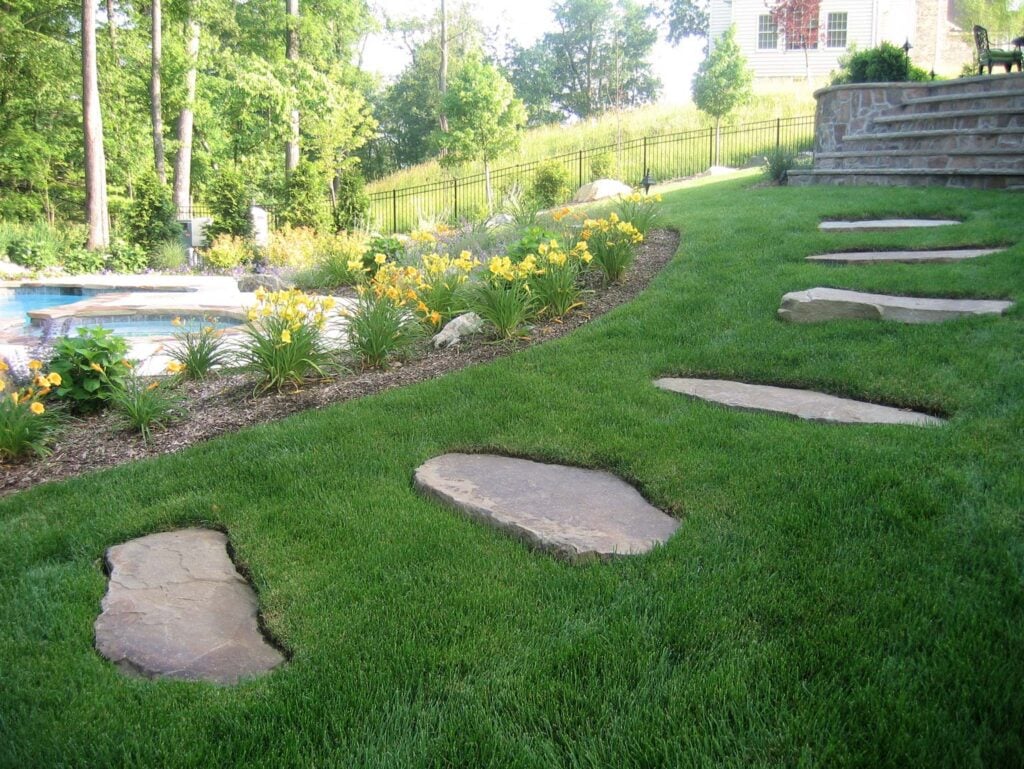 Before and after transformation of a New Jersey backyard by CLC Landscape Design, featuring upgraded patio, outdoor living area, and detailed landscaping.