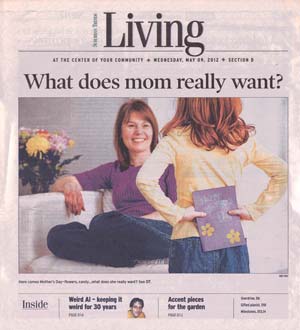 Cover of Suburban Trends Living section from May 9, 2012, showing a smiling mother sitting on a couch as her daughter surprises her with a Mother’s Day card.