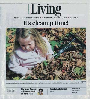 Cover of Suburban Trends Living section from October 12, 2011, showing a young girl playing in autumn leaves with a rake.