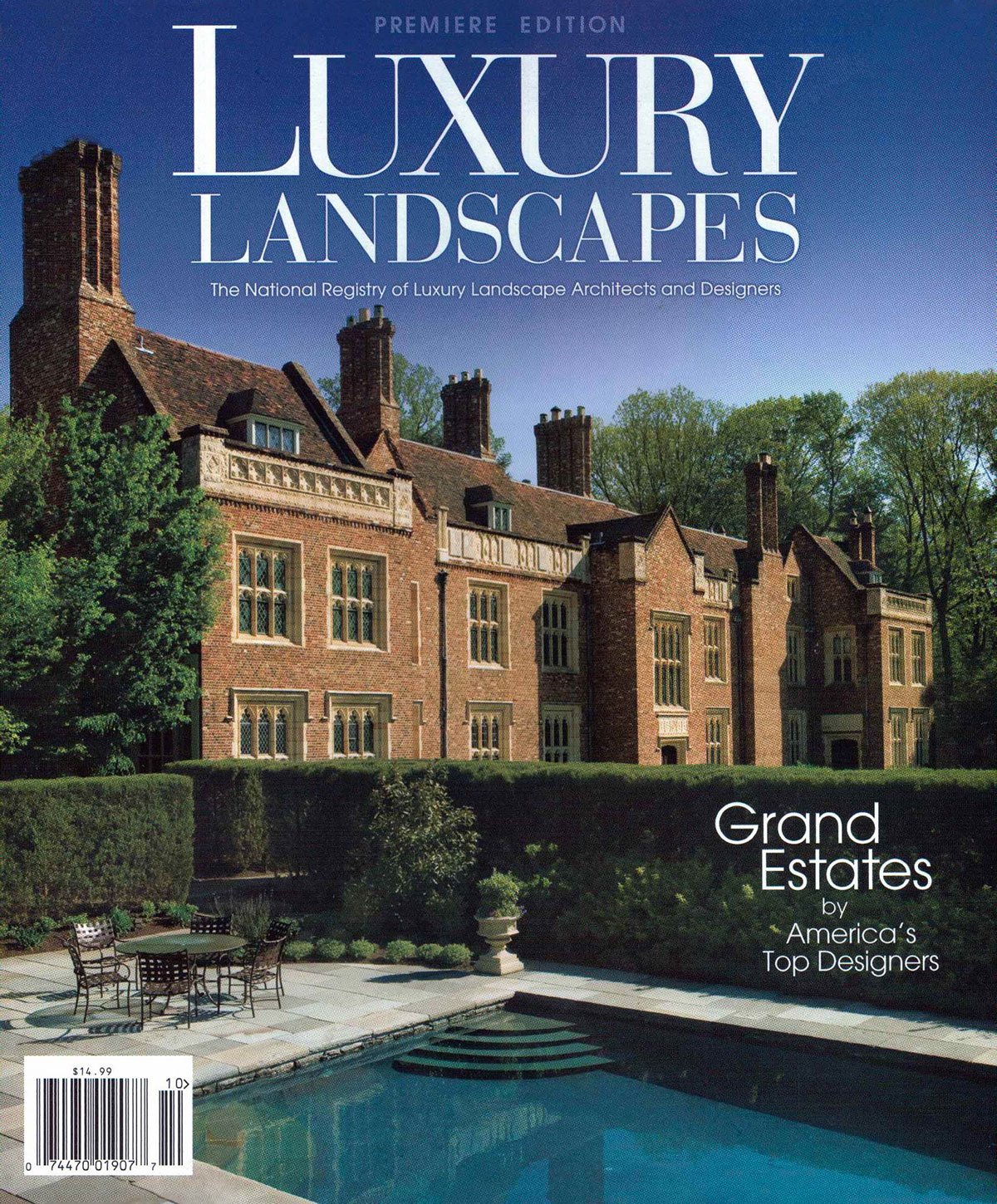 Cover of Luxury Landscapes Magazine Premiere Edition featuring a stately brick estate with manicured hedges and a formal pool in the foreground.