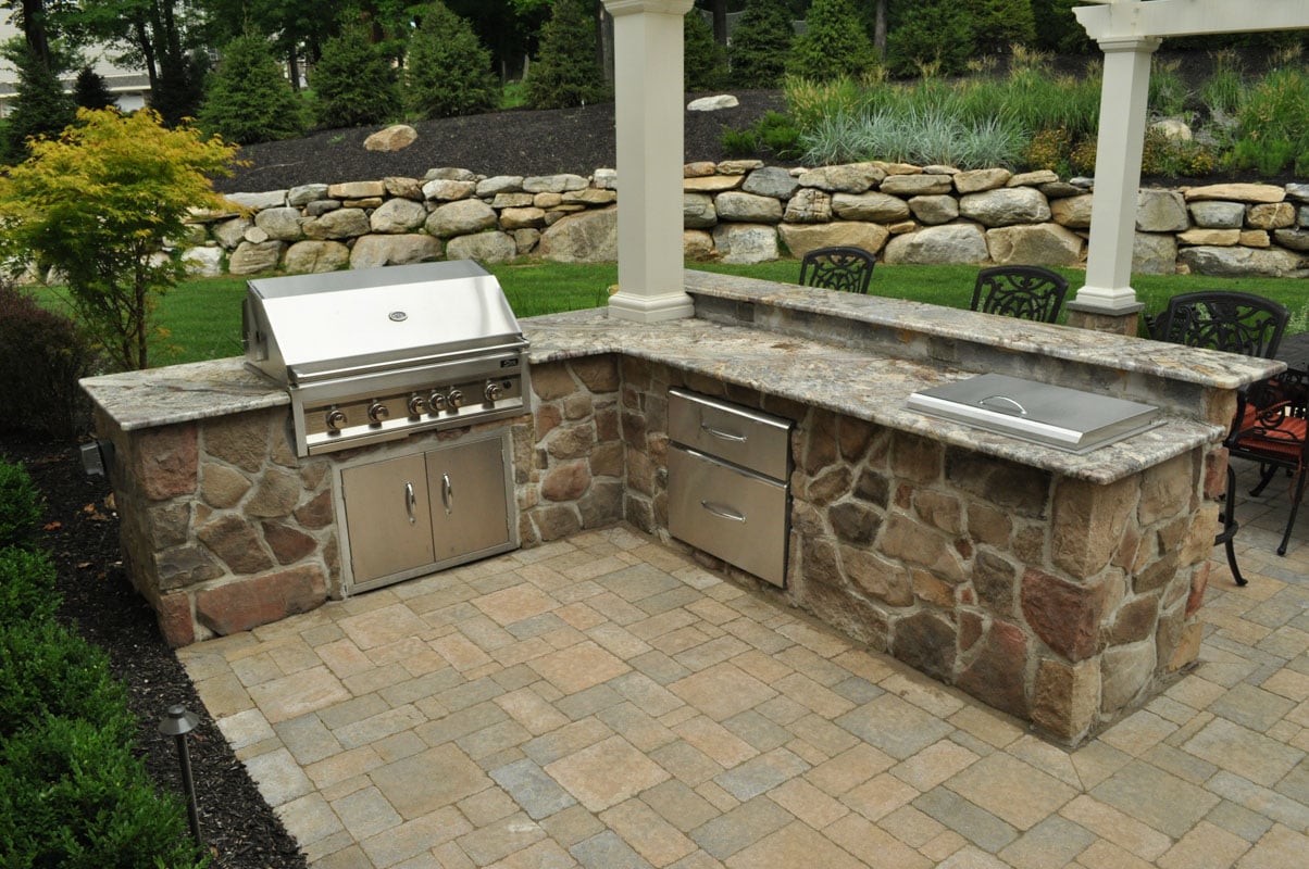 New Jersey outdoor kitchen with built-in grill and stone detailing by CLC Landscaping.