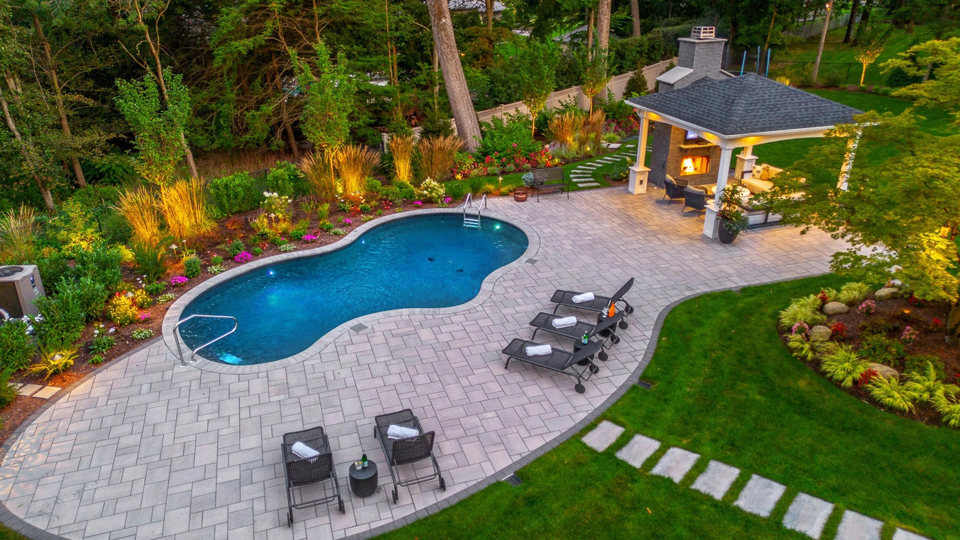 Custom outdoor living design with fire feature and hot tub by CLC in Woodcliff Lake, New Jersey