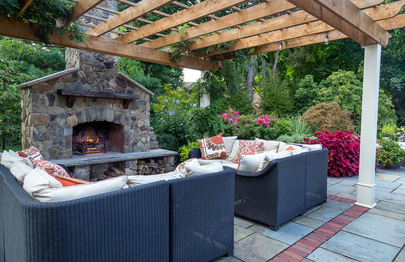 Intimate backyard lounge area surrounded by flowering borders and privacy plantings in Franklin Lakes, NJ — designed for family-friendly outdoor living.