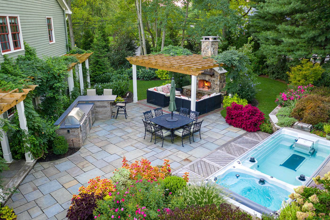 Winding garden pathway lined with flowering annuals and shade-loving plants in a peaceful Franklin Lakes, NJ backyard design.