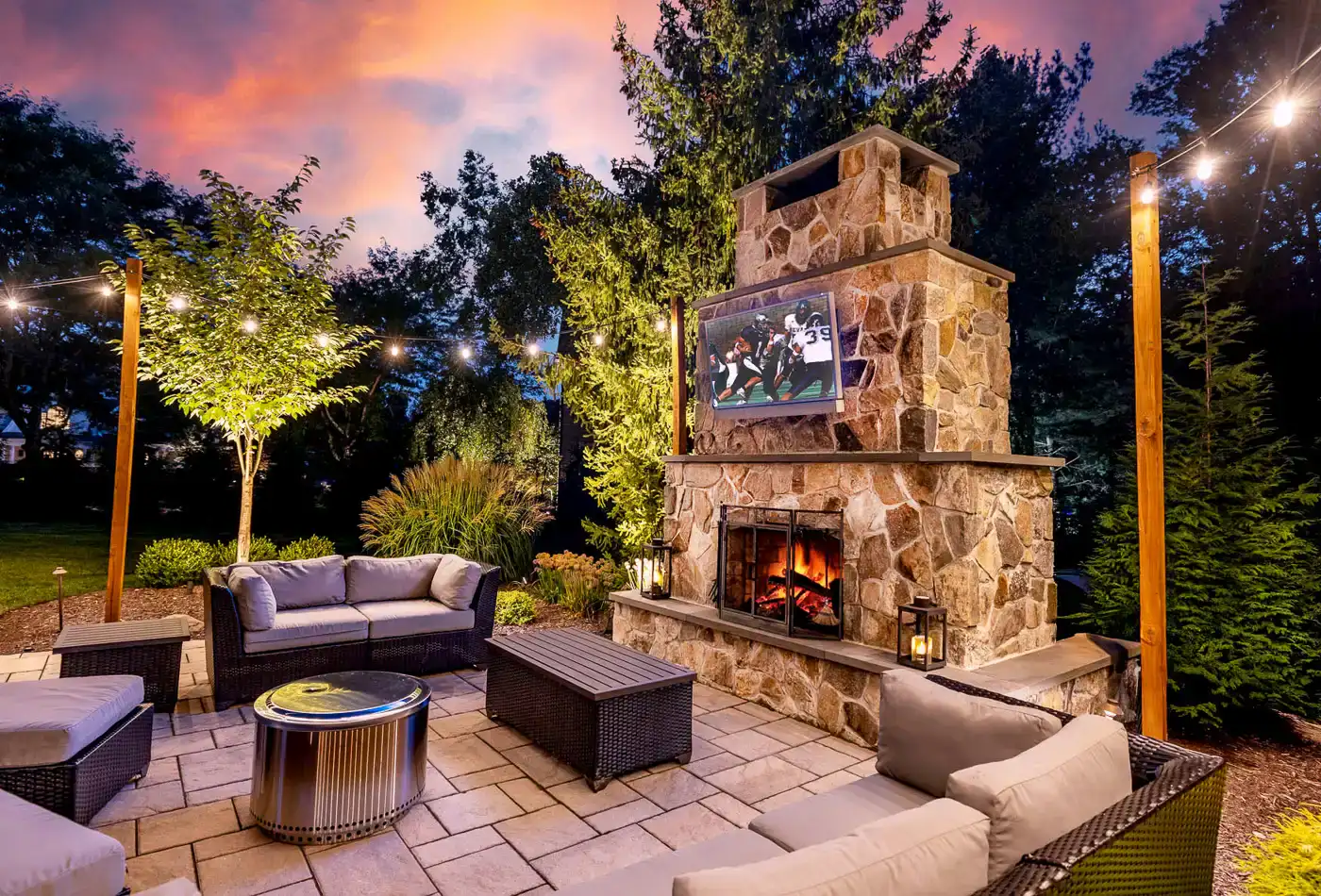 Stone outdoor fireplace installation by CLC Landscape Design NJ.
