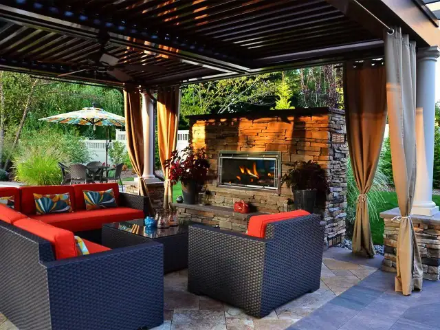 Stone fireplace, patio design NJ backyard by CLC Landscape Design.